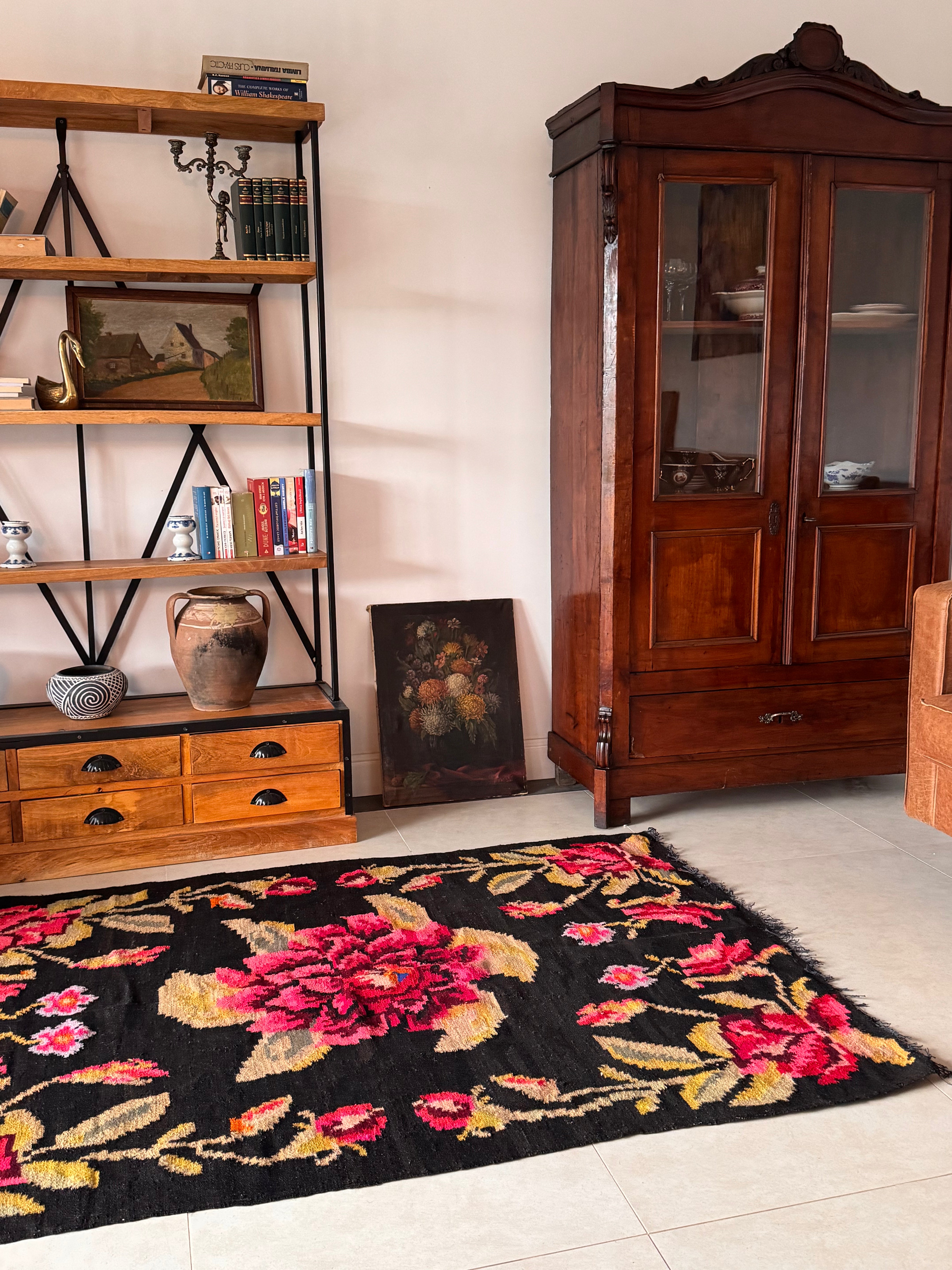Authentic vintage Romanian rug with colourful flowers on a dark background