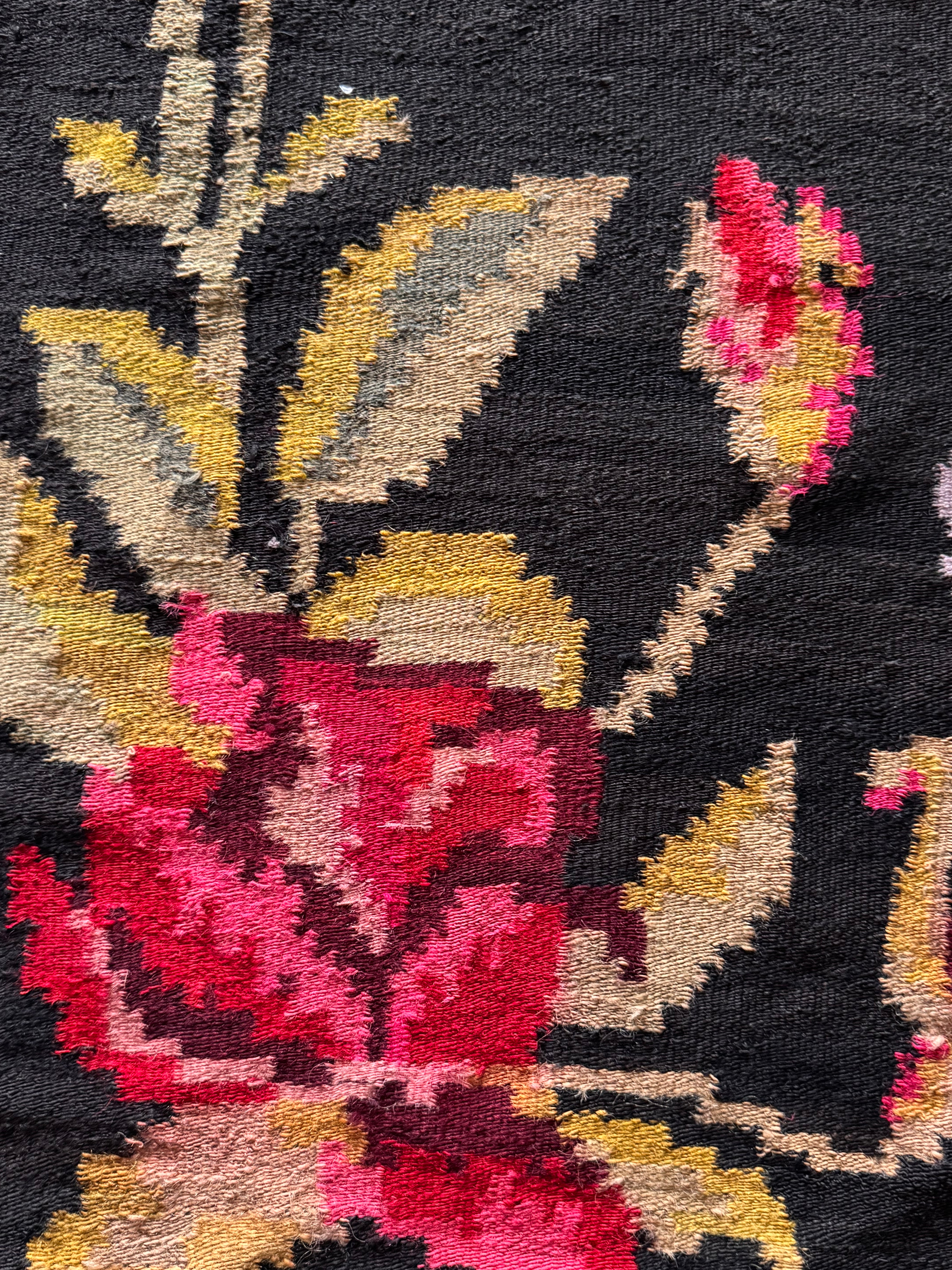 Traditional Maramureș rug decorated with pink, red and yellow flowers
